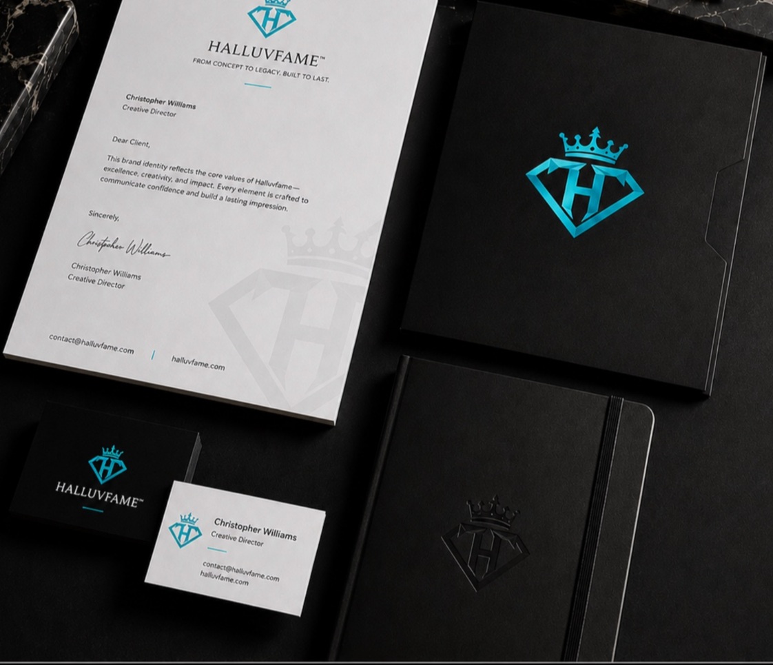 Halluvfame identity applied to letterhead, a presentation folder, business cards, and notebooks on a dark desk.