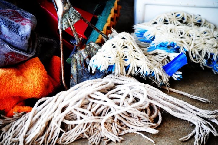 Coiled ropes, cotton mop heads, towels, and work equipment gathered together